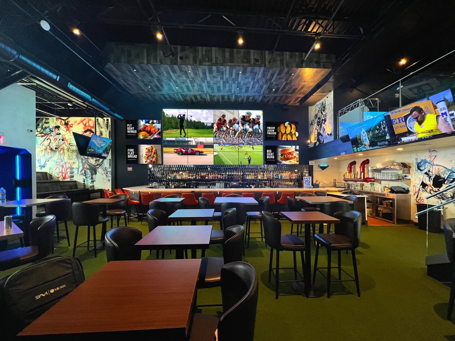 A wall of screens in a sports bar