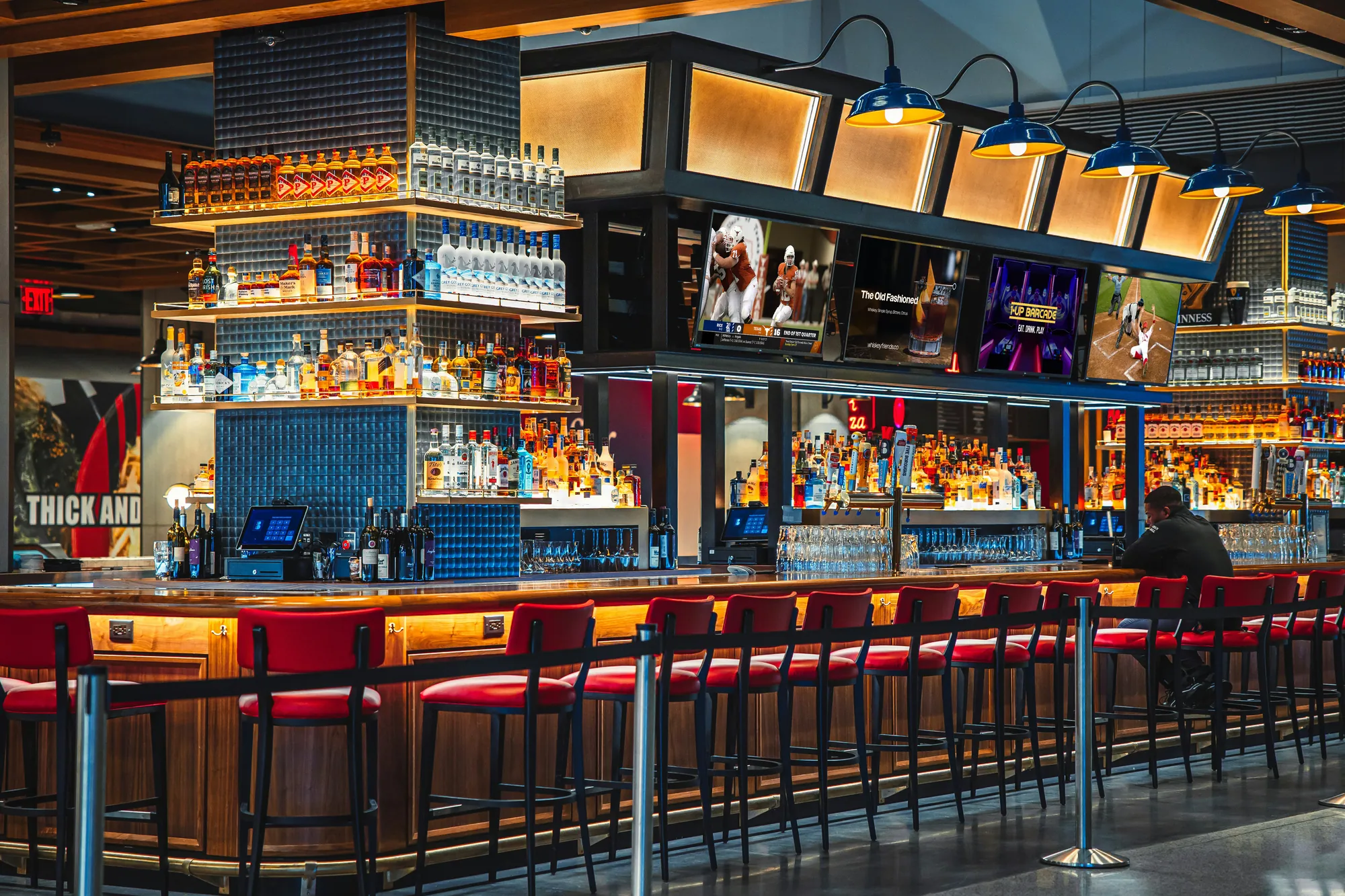 A venue with SAVI-powered digital signage screens above the bar